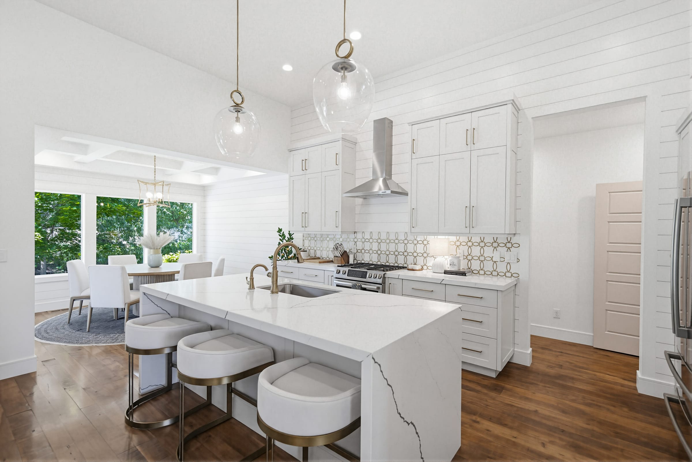 An airy white kitchen with island